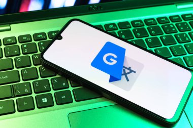 Prag, Çek Cumhuriyeti - 09 02 2025: Laptop klavyesindeki telefon renkli ışık göstergesi Google Translate logosunu gösteriyor. Google Çevirisi metni ve konuşmayı diller arası çevirmek için bir platformdur..
