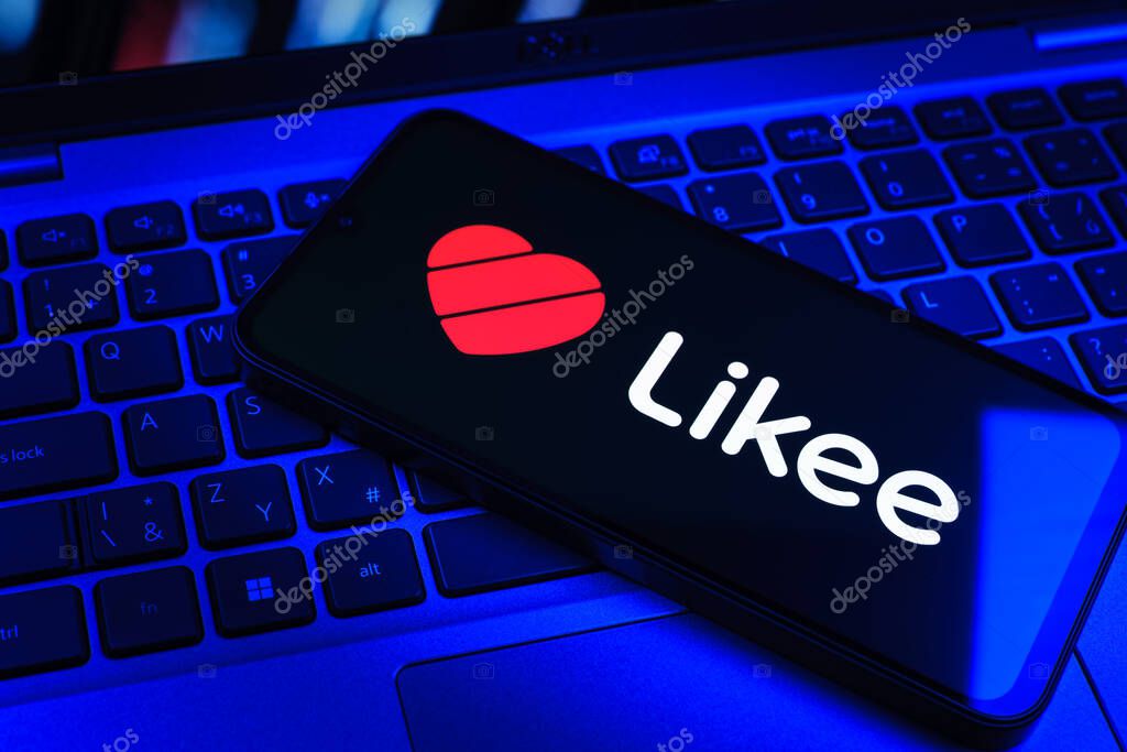 Prague, Czechia - 09 02 2025: Phone on laptop keyboard lit by colored light shows Likee logo. Likee is a platform for creating and sharing short videos.