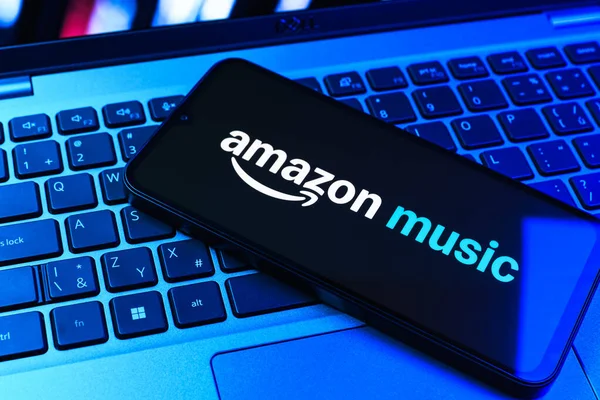 Prag, Çek Cumhuriyeti - 09 02 2025: Renkli ışık tarafından aydınlatılan dizüstü bilgisayardaki telefon Amazon Müzik logosunu gösteriyor. Amazon Müzik müzik müzik için bir platformdur..