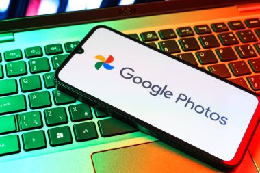 Prag, Çek Cumhuriyeti - 09 02 2025: Laptop klavyesindeki telefon renkli ışık göstergeleri Google Photos logosunu gösteriyor. Google Fotoğrafları fotoğraf ve videoları saklamak ve düzenlemek için bir platformdur.