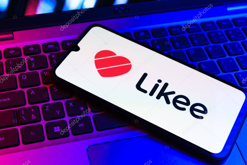 Prague, Czechia - 09 02 2025: Phone on laptop keyboard lit by colored light shows Likee logo. Likee is a platform for creating and sharing short videos.