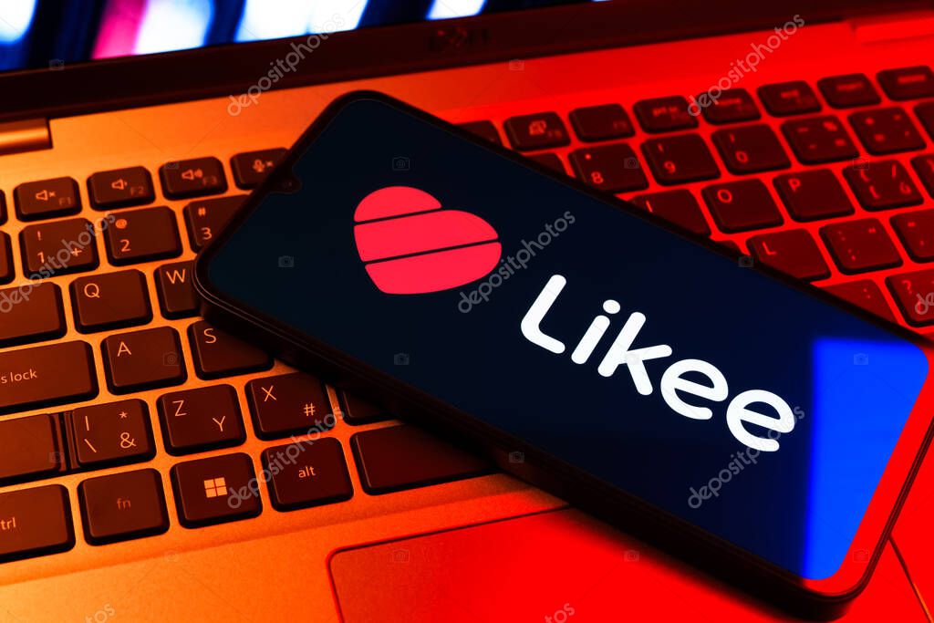 Prague, Czechia - 09 02 2025: Phone on laptop keyboard lit by colored light shows Likee logo. Likee is a platform for creating and sharing short videos.
