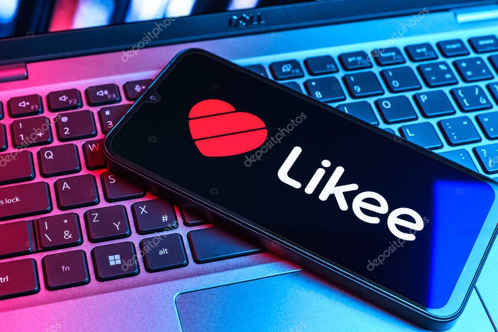 Prague, Czechia - 09 02 2025: Phone on laptop keyboard lit by colored light shows Likee logo. Likee is a platform for creating and sharing short videos.