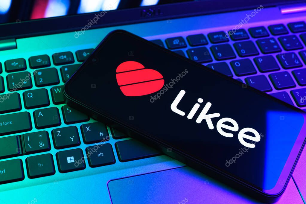 Prague, Czechia - 09 02 2025: Phone on laptop keyboard lit by colored light shows Likee logo. Likee is a platform for creating and sharing short videos.