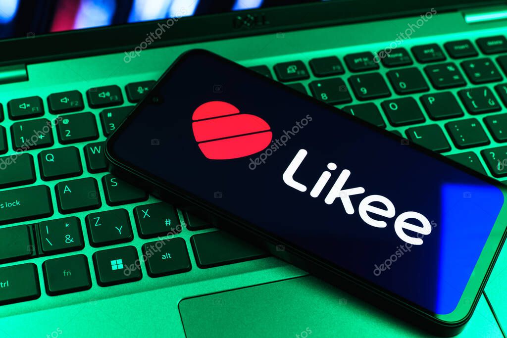 Prague, Czechia - 09 02 2025: Phone on laptop keyboard lit by colored light shows Likee logo. Likee is a platform for creating and sharing short videos.