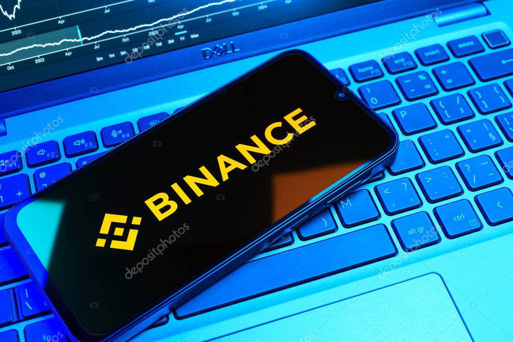 Prague, Czechia - 08 18 2025: A mobile phone on a keyboard displays Binance logo. Binance is a cryptocurrency exchange for trading digital assets.
