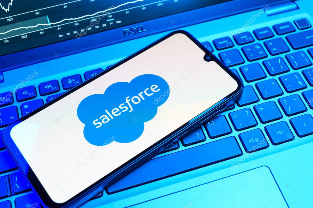 Prague, Czechia - 08 18 2025: A mobile phone on a keyboard displays Salesforce logo. Salesforce is a platform for customer relationship management and cloud services.