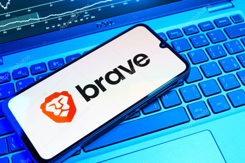 Prague, Czechia - 08 18 2025: A mobile phone on a keyboard displays Brave logo. Brave is a web browser focused on privacy and speed.