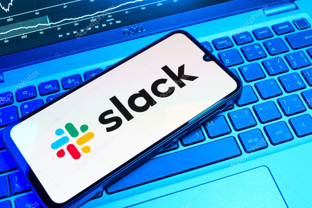 Prague, Czechia - 08 18 2025: A mobile phone on a keyboard displays Slack logo. Slack is a platform for team messaging and workplace communication.