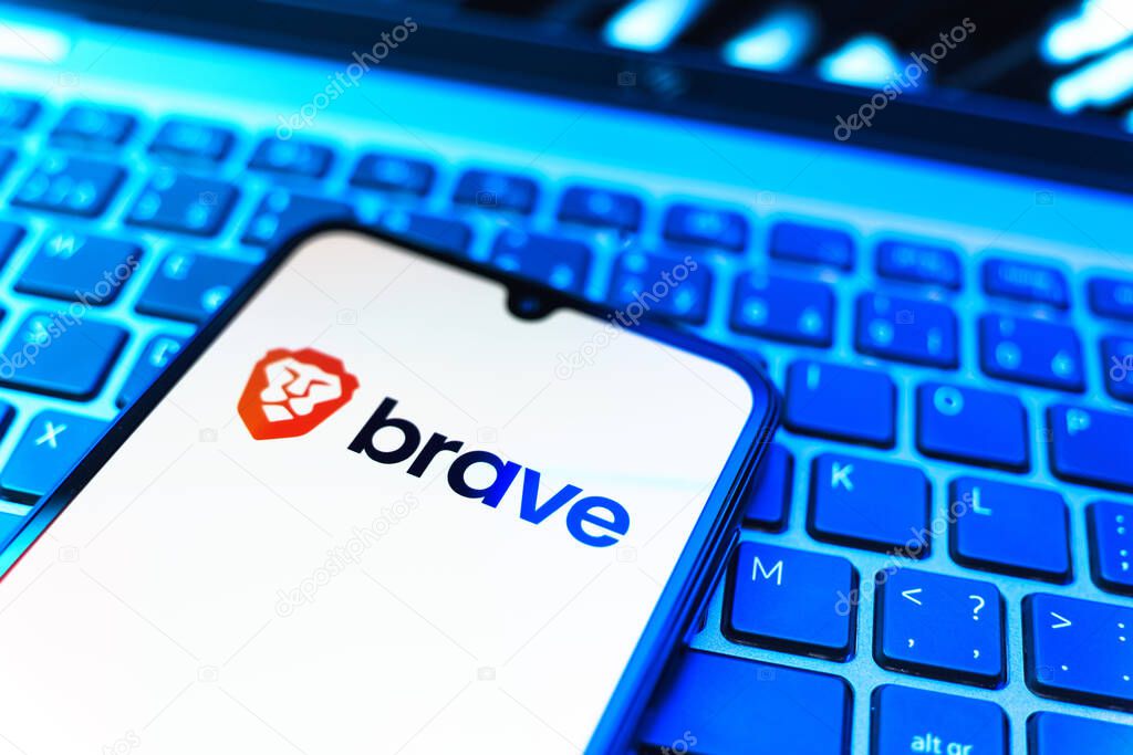Prague, Czechia - 08 19 2025: A close-up view of a mobile phone lying on a keyboard, displaying Brave logo. Brave is a web browser focused on privacy and speed.