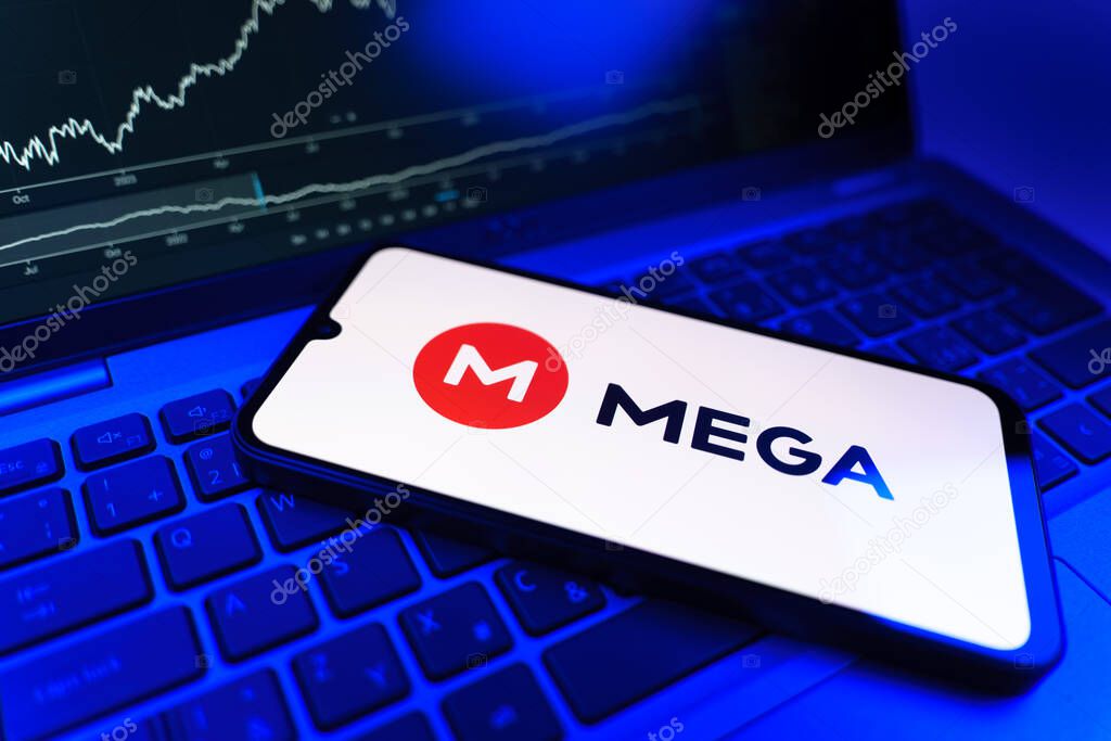 Prague, Czechia - 09 02 2025: Phone on laptop with stock chart showing Mega logo. Mega is a platform for cloud storage with encrypted file sharing.