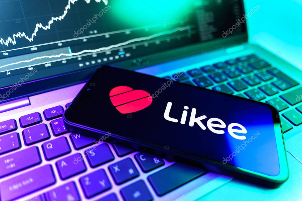 Prague, Czechia - 09 02 2025: Phone on laptop with stock chart showing Likee logo. Likee is a platform for creating and sharing short videos.