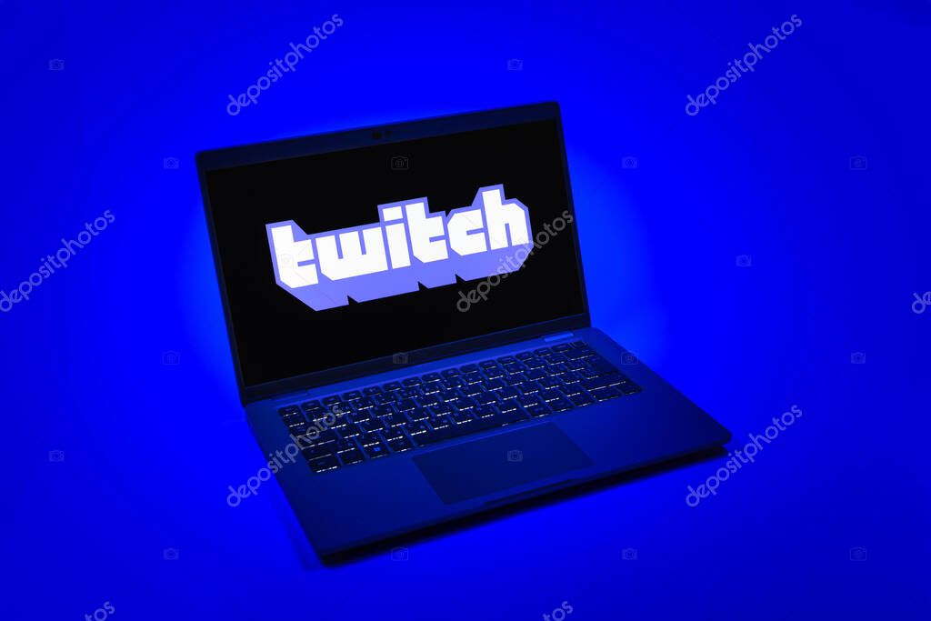 Prague, Czechia - 08 12 2025: A top-down view of a laptop on a uniform background displaying the Twitch logo. Twitch is a platform for live streaming games and content.