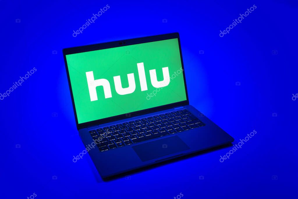 Prague, Czechia - 08 12 2025: A top-down view of a laptop on a uniform background displaying the Hulu logo. Hulu is a streaming platform for TV shows, movies, and live TV.