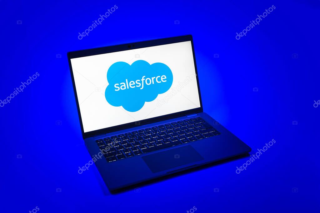 Prague, Czechia - 08 12 2025: A top-down view of a laptop on a uniform background displaying the Salesforce logo. Salesforce is a platform for customer relationship management and cloud services.