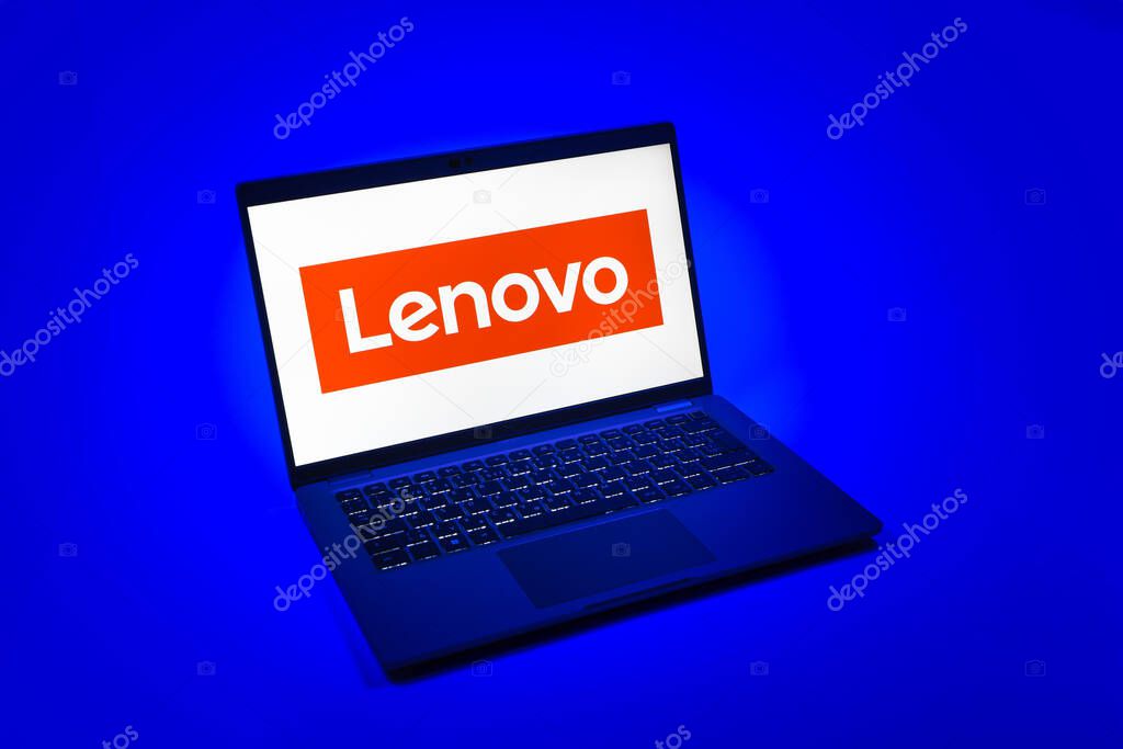Prague, Czechia - 08 12 2025: A top-down view of a laptop on a uniform background displaying the Lenovo logo. Lenovo is a technology company producing computers and electronics.