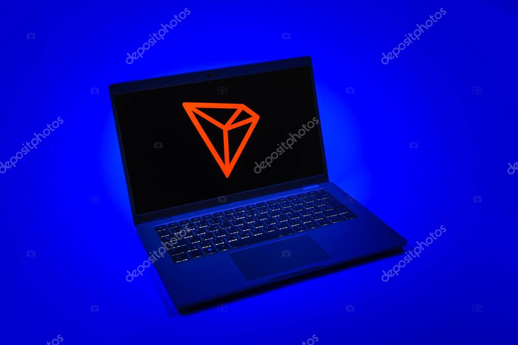 Prague, Czechia - 08 12 2025: A top-down view of a laptop on a uniform background displaying the Tron logo. Tron is a blockchain platform for decentralized applications.