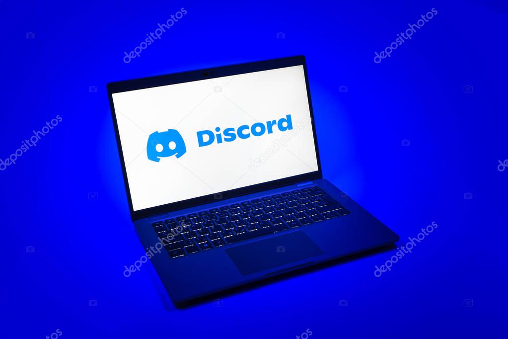 Prague, Czechia - 08 12 2025: A top-down view of a laptop on a uniform background displaying the Discord logo. Discord is a platform for voice, video, and text communication.