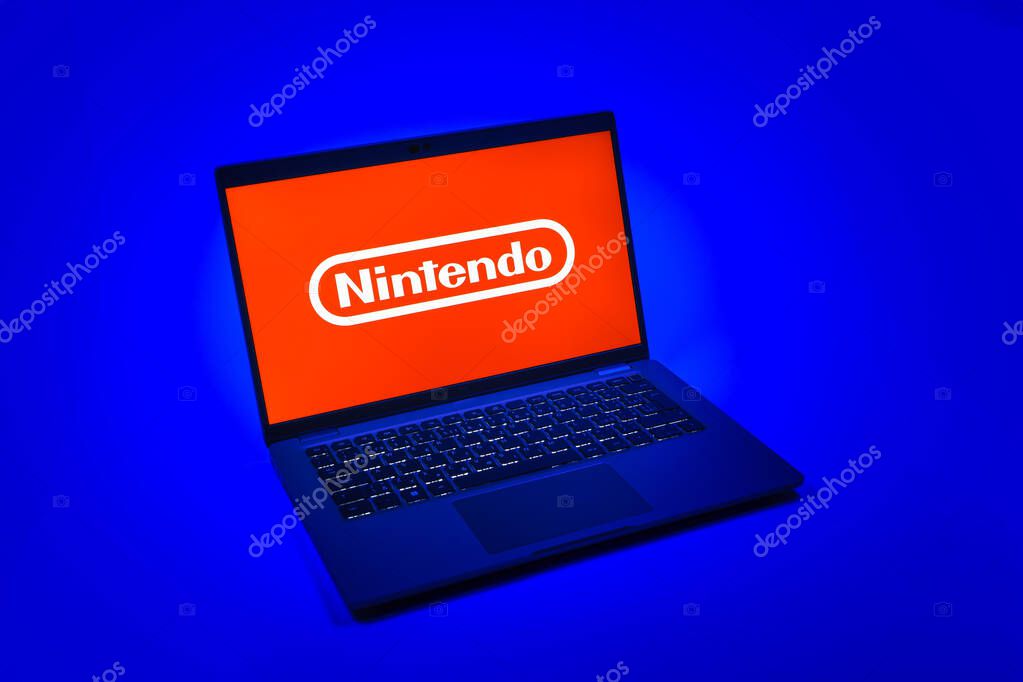 Prague, Czechia - 08 12 2025: A top-down view of a laptop on a uniform background displaying the Nintendo logo. Nintendo is a company producing video game consoles and games.