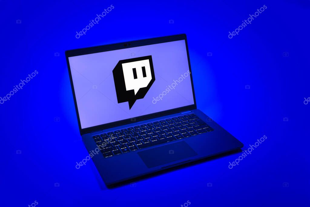 Prague, Czechia - 08 12 2025: A top-down view of a laptop on a uniform background displaying the Twitch logo. Twitch is a platform for live streaming games and content.