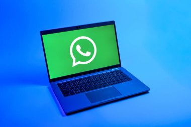 Prag, Çek Cumhuriyeti - 08 12 2025: Tek bir arkaplanda WhatsApp logosunu gösteren bir dizüstü bilgisayarın yukarıdan görünüşü. WhatsApp mesaj, çağrı ve medya göndermek için bir uygulamadır.