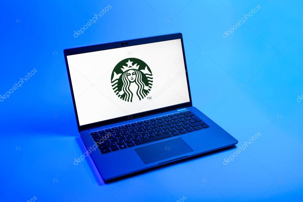 Prague, Czechia - 08 12 2025: A top-down view of a laptop on a uniform background displaying the Starbucks logo. Starbucks is a global coffeehouse chain serving beverages and food.