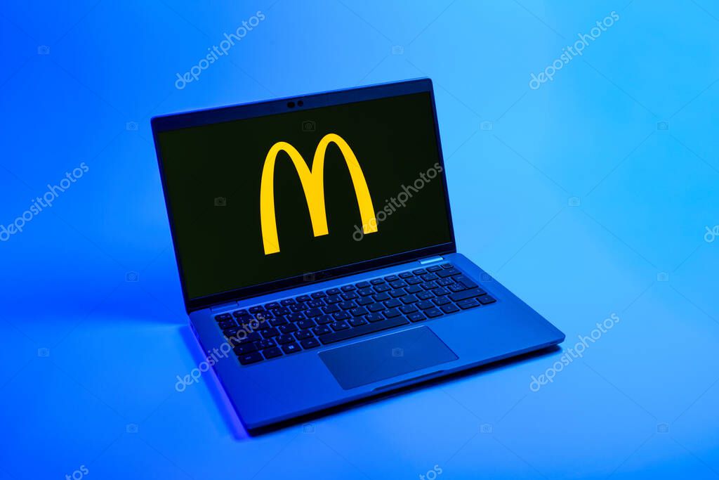 Prague, Czechia - 08 12 2025: A top-down view of a laptop on a uniform background displaying the McDonalds logo. McDonalds is a fast-food chain serving burgers, fries, and more.