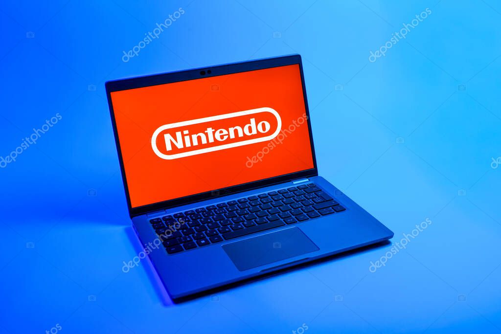 Prague, Czechia - 08 12 2025: A top-down view of a laptop on a uniform background displaying the Nintendo logo. Nintendo is a company producing video game consoles and games.