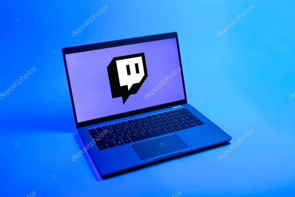 Prague, Czechia - 08 12 2025: A top-down view of a laptop on a uniform background displaying the Twitch logo. Twitch is a platform for live streaming games and content.