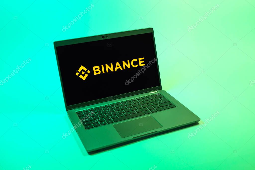 Prague, Czechia - 08 12 2025: A top-down view of a laptop on a uniform background displaying the Binance logo. Binance is a cryptocurrency exchange for trading digital assets.