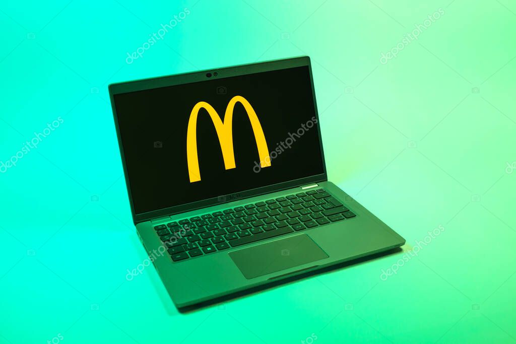 Prague, Czechia - 08 12 2025: A top-down view of a laptop on a uniform background displaying the McDonalds logo. McDonalds is a fast-food chain serving burgers, fries, and more.