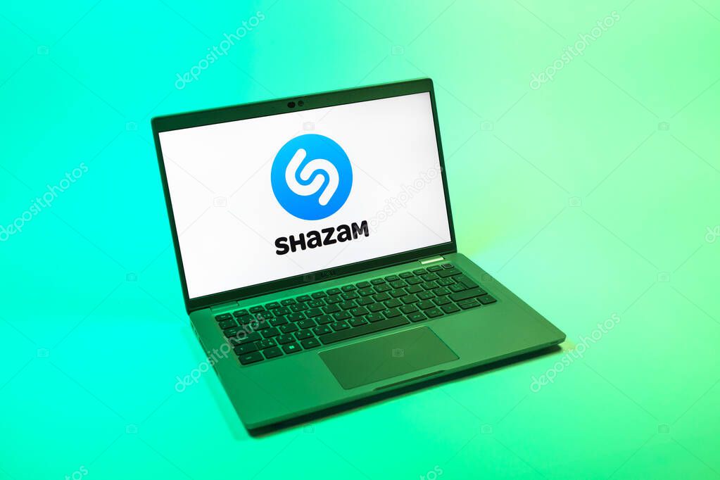 Prague, Czechia - 08 12 2025: A top-down view of a laptop on a uniform background displaying the Shazam logo. Shazam is an app for identifying songs and music tracks.