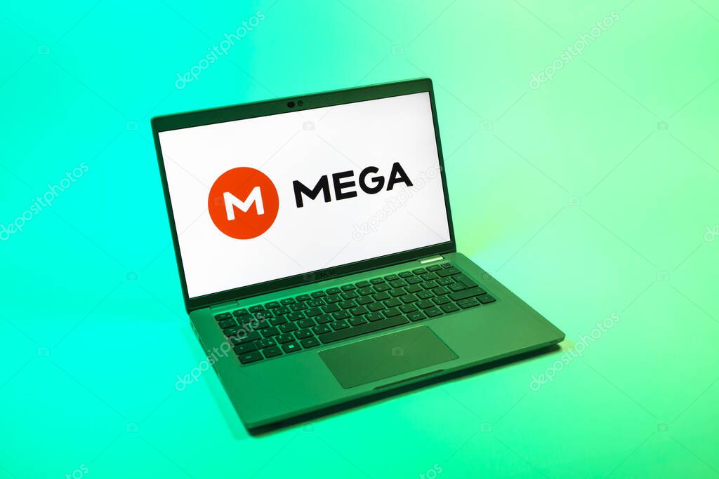Prague, Czechia - 08 12 2025: A top-down view of a laptop on a uniform background displaying the Mega logo. Mega is a platform for cloud storage with encrypted file sharing.