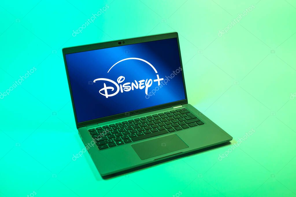 Prague, Czechia - 08 12 2025: A top-down view of a laptop on a uniform background displaying the Disney+ logo. Disney + is a streaming platform for movies and TV shows.