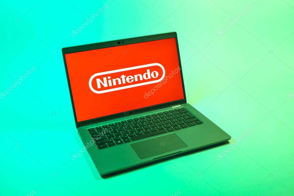 Prague, Czechia - 08 12 2025: A top-down view of a laptop on a uniform background displaying the Nintendo logo. Nintendo is a company producing video game consoles and games.