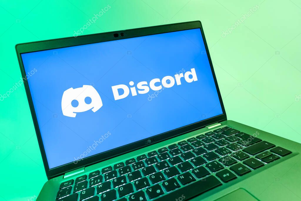 Prague, Czechia - 08 12 2025: A dynamic close-up of a laptop displaying the Discord logo. Discord is a platform for voice, video, and text communication.