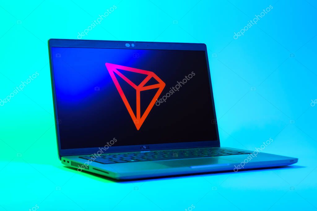 Prague, Czechia - 05 18 2025: A low-angle view of a laptop displaying Tron logo. Tron is a blockchain platform for decentralized applications.