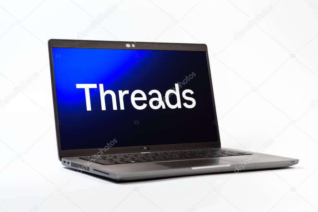 Prague, Czechia - 05 18 2025: A low-angle view of a laptop displaying Threads logo. Threads is a social media platform for sharing short posts and updates.