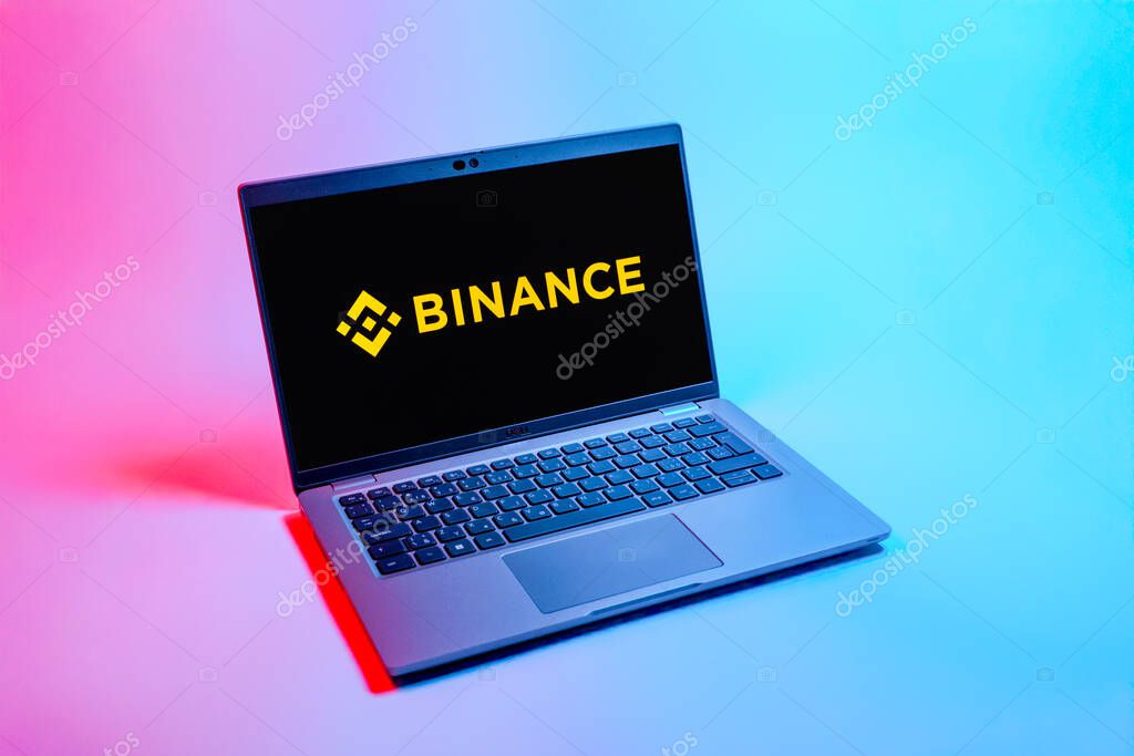 Prague, Czechia - 08 12 2025: A top-down view of a laptop on a uniform background displaying the Binance logo. Binance is a cryptocurrency exchange for trading digital assets.