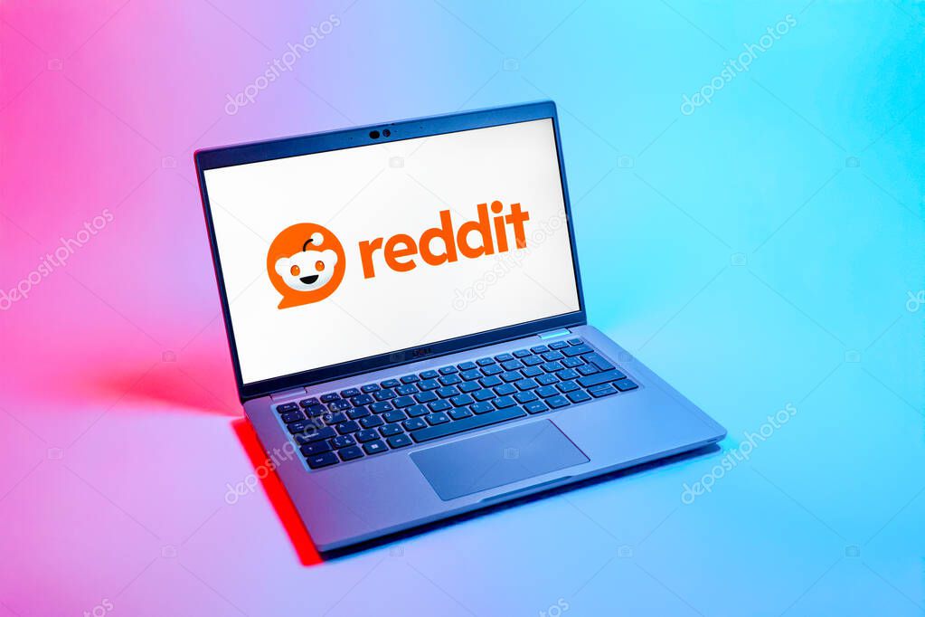 Prague, Czechia - 08 12 2025: A top-down view of a laptop on a uniform background displaying the Reddit logo. Reddit is a platform for discussion, news, and community content.