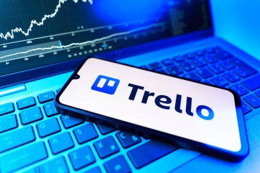 Prag, Çek Cumhuriyeti - 09 02 2025: Trello logosunu gösteren dizüstü bilgisayarlı telefon. Trello, tahta ve görevleri kullanarak proje yönetimi için bir platformdur.