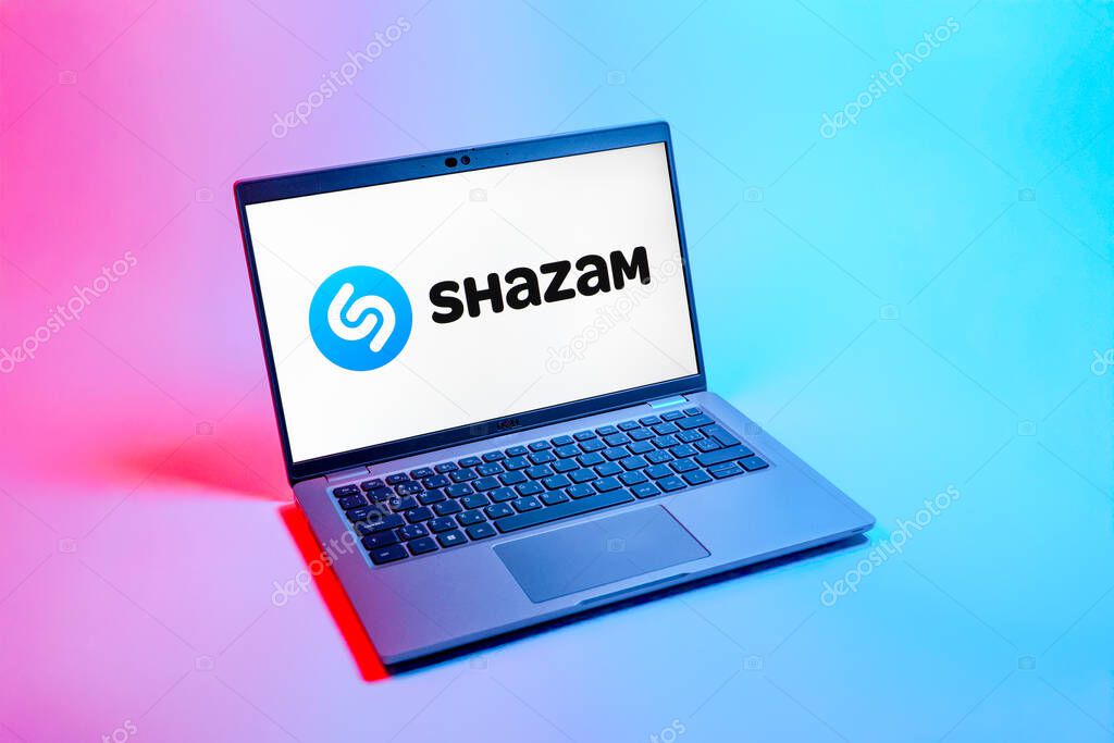 Prague, Czechia - 08 12 2025: A top-down view of a laptop on a uniform background displaying the Shazam logo. Shazam is an app for identifying songs and music tracks.