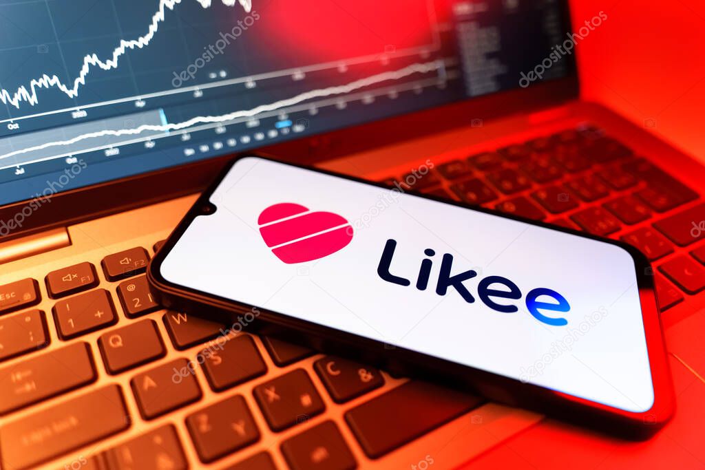Prague, Czechia - 09 02 2025: Phone on laptop with stock chart showing Likee logo. Likee is a platform for creating and sharing short videos.