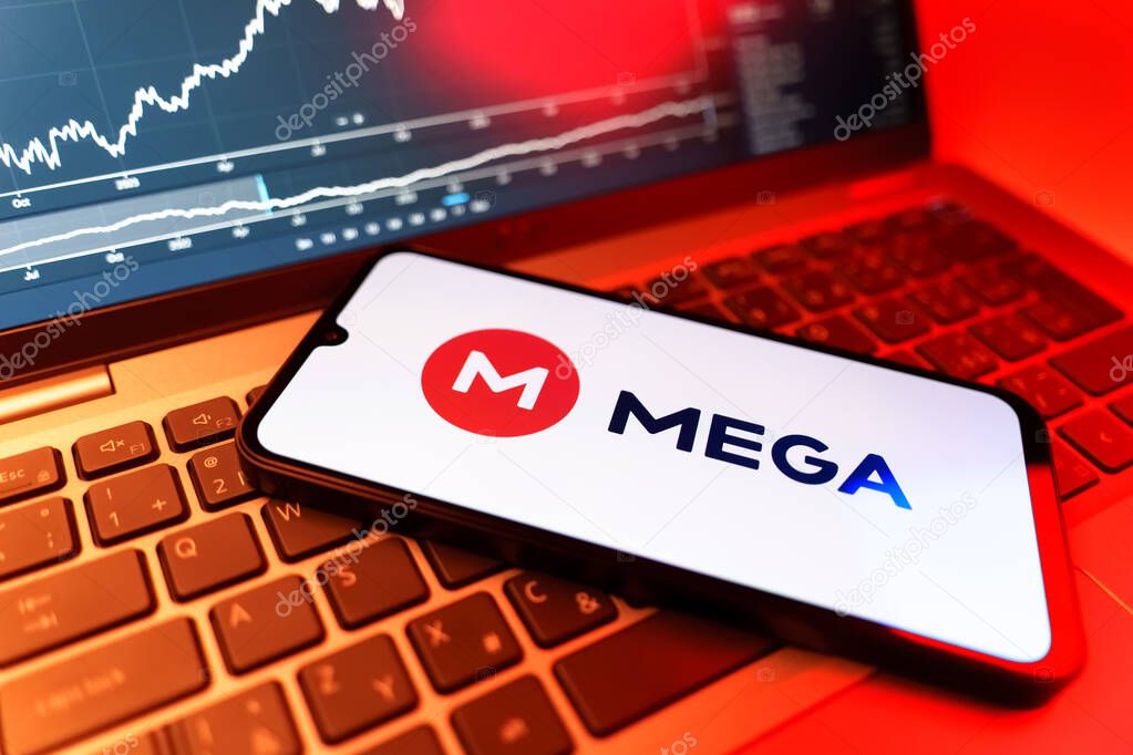 Prague, Czechia - 09 02 2025: Phone on laptop with stock chart showing Mega logo. Mega is a platform for cloud storage with encrypted file sharing.