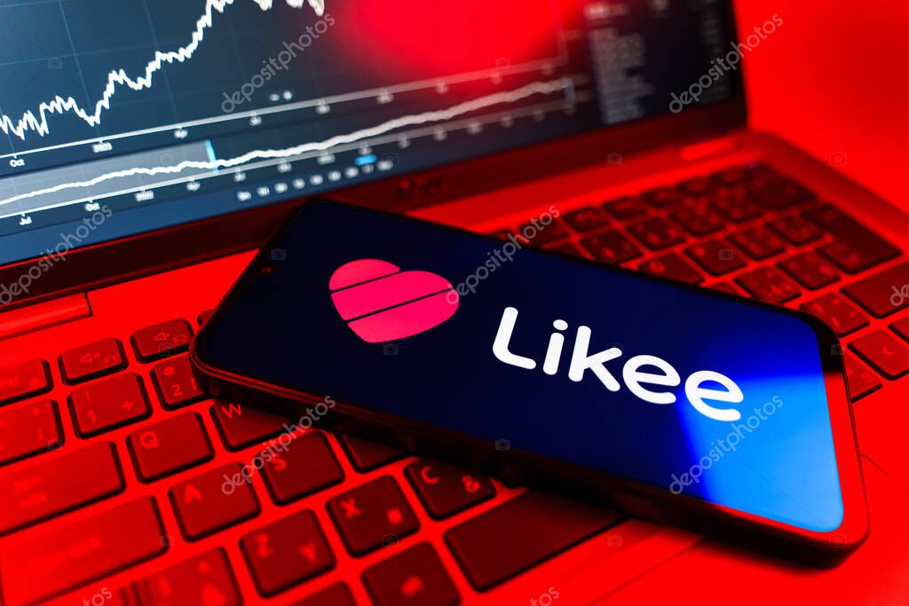 Prague, Czechia - 09 02 2025: Phone on laptop with stock chart showing Likee logo. Likee is a platform for creating and sharing short videos.
