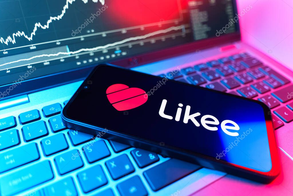 Prague, Czechia - 09 02 2025: Phone on laptop with stock chart showing Likee logo. Likee is a platform for creating and sharing short videos.