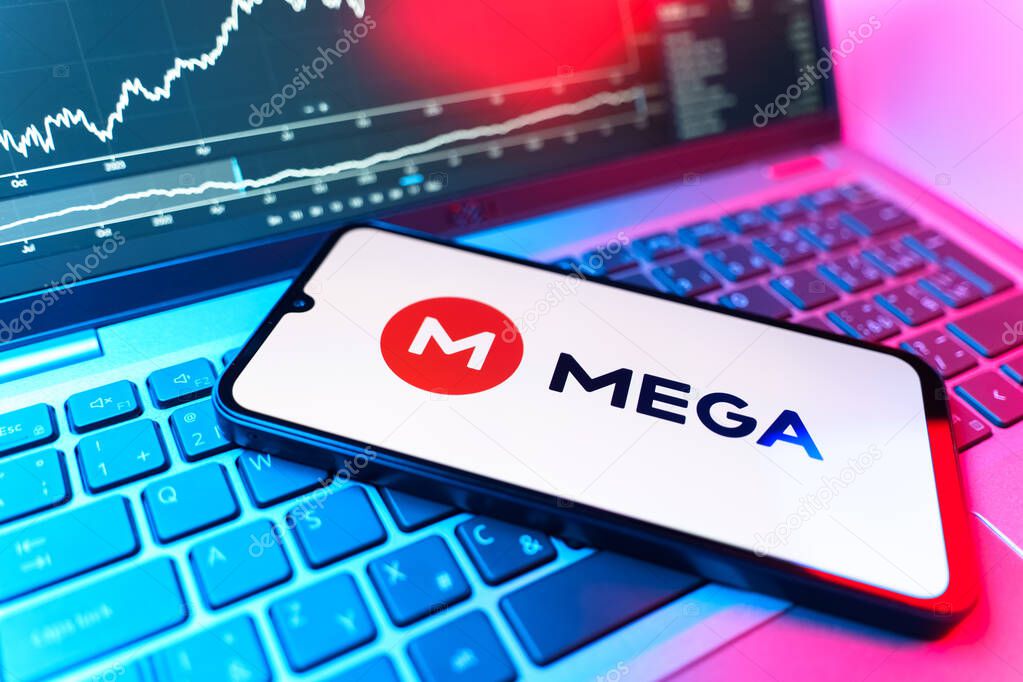 Prague, Czechia - 09 02 2025: Phone on laptop with stock chart showing Mega logo. Mega is a platform for cloud storage with encrypted file sharing.