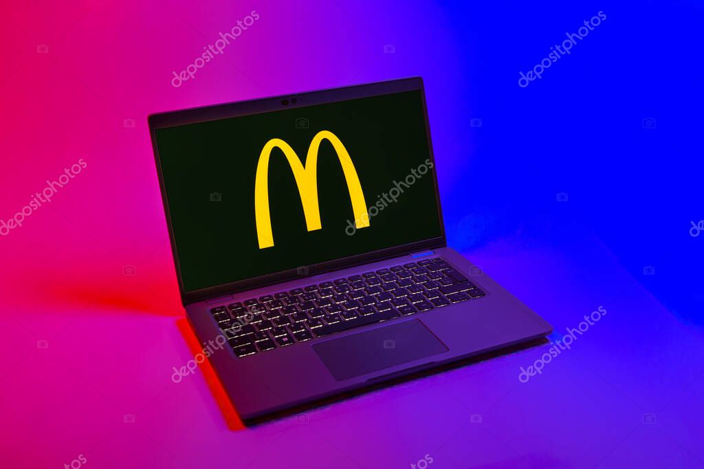 Prague, Czechia - 08 12 2025: A top-down view of a laptop on a uniform background displaying the McDonalds logo. McDonalds is a fast-food chain serving burgers, fries, and more.