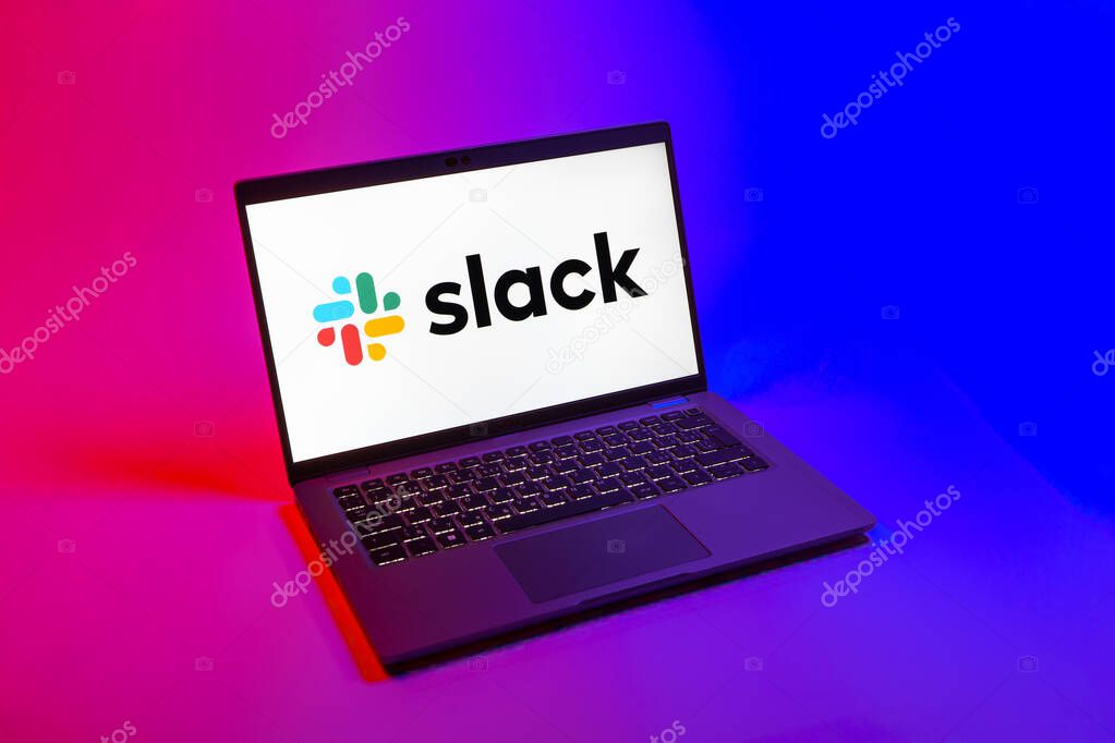 Prague, Czechia - 08 12 2025: A top-down view of a laptop on a uniform background displaying the Slack logo. Slack is a platform for team messaging and workplace communication.