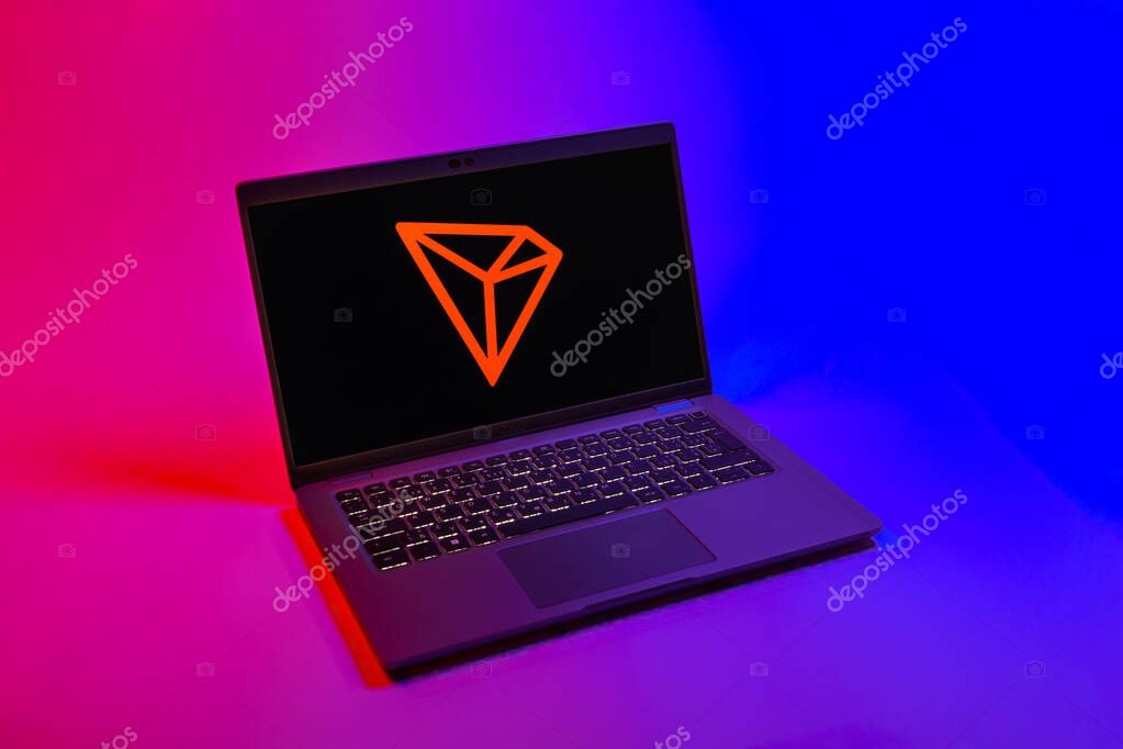 Prague, Czechia - 08 12 2025: A top-down view of a laptop on a uniform background displaying the Tron logo. Tron is a blockchain platform for decentralized applications.